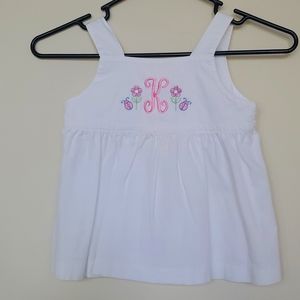 White top with monogrammed "K"